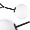Luminaire suspendu Atom 8, suspension multidirectionnelle au corps noir et abat-jour en verre blanc pour un design contemporain, dynamique, urbain et unique par Maillé Style (Érik Maillé)