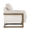 La chaise crème Céline est un fauteuil d'appoint en tissu doux blanc cassé avec une structure visible bronze rustique pour un design contemporain et confortable par Maillé Style (Érik Maillé)