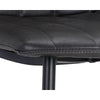 La chaise de salle à manger Drew est compacte et son look décontracté  par le cuir  brun  noir capitonné en canal et ses pattes de métal noir par Maillé Style (Érik Maillé)