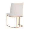 Chaise de salle à manger Ray, chaise élégante et légère avec son tissu crème et sa base arrondie en laiton dorée par Maillé Style (Érik Maillé)